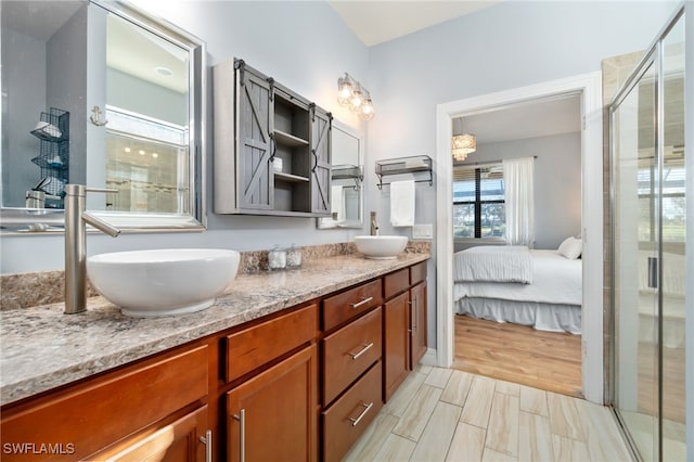 bathroom with hardwood / wood-style floors, vanity, and walk in shower