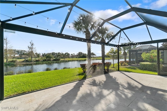 view of patio featuring a water view and glass enclosure