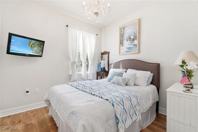 bedroom featuring light hardwood / wood-style floors and an inviting chandelier