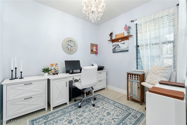 office area with light hardwood / wood-style flooring and a notable chandelier