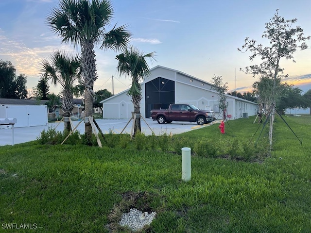 property exterior at dusk with a yard