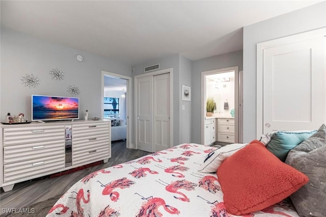 bedroom with ensuite bath, a closet, and dark wood-type flooring