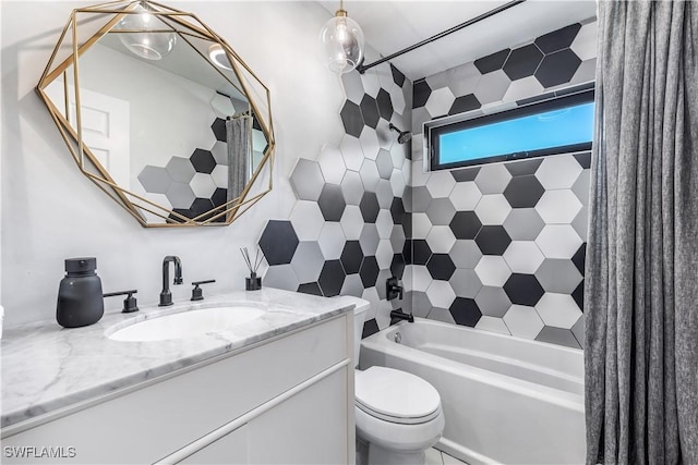 full bathroom with vanity, tiled shower / bath combo, and toilet