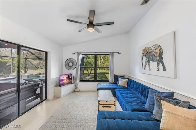 living room with ceiling fan, light wood-type flooring, and lofted ceiling