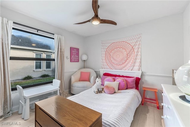 bedroom with ceiling fan and light wood-type flooring