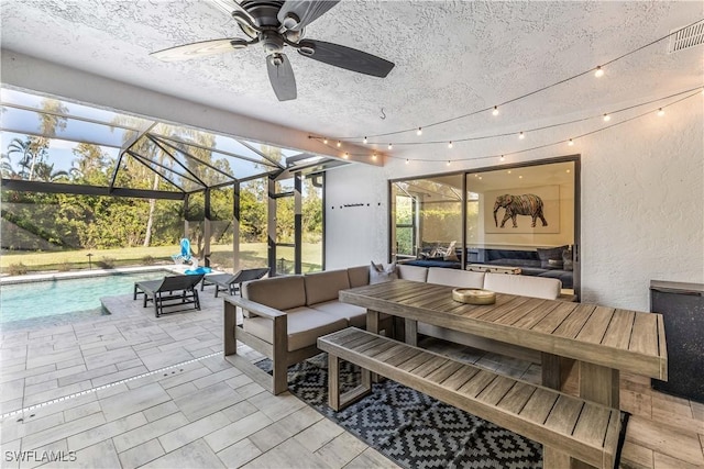 view of patio / terrace with an outdoor hangout area, glass enclosure, and ceiling fan