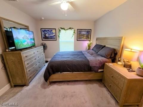 bedroom featuring ceiling fan and light carpet