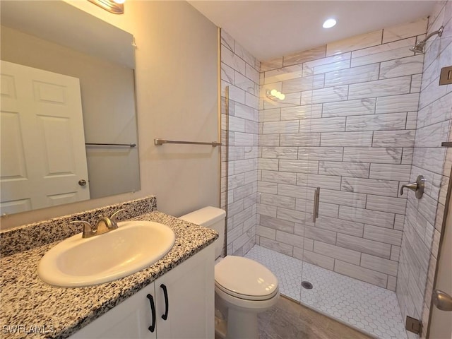 bathroom with vanity, toilet, and walk in shower