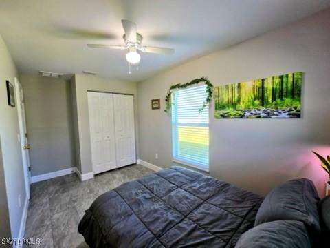 carpeted bedroom featuring a closet and ceiling fan