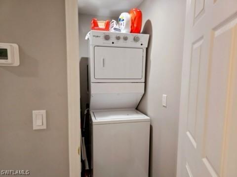 laundry area with stacked washing maching and dryer