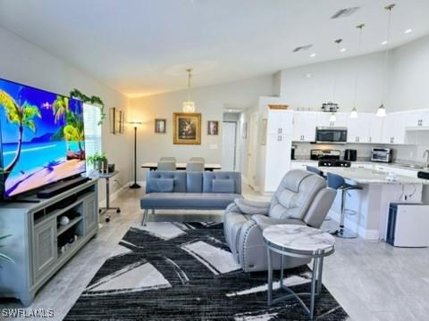 living room featuring vaulted ceiling