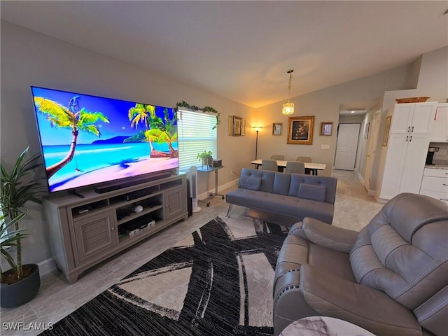 living room featuring lofted ceiling