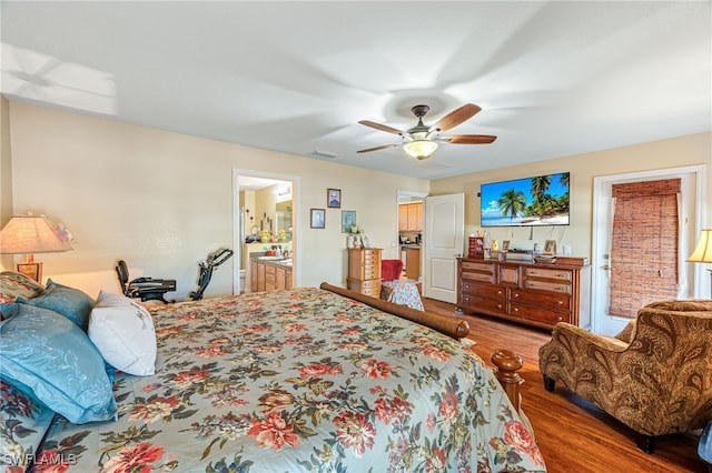 bedroom with wood-type flooring, ensuite bathroom, and ceiling fan