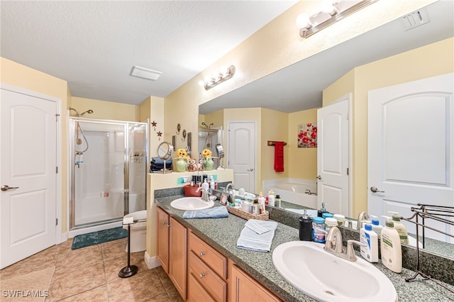 bathroom featuring vanity, tile patterned floors, a textured ceiling, and separate shower and tub