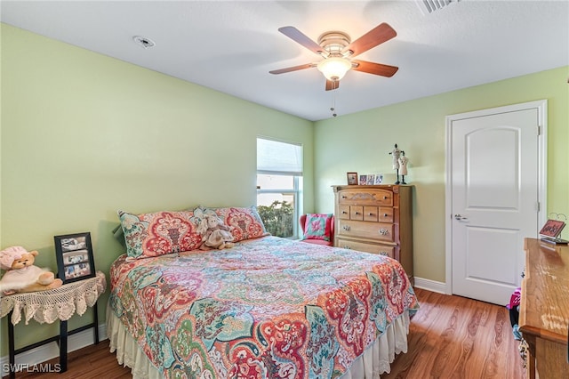 bedroom with hardwood / wood-style flooring and ceiling fan