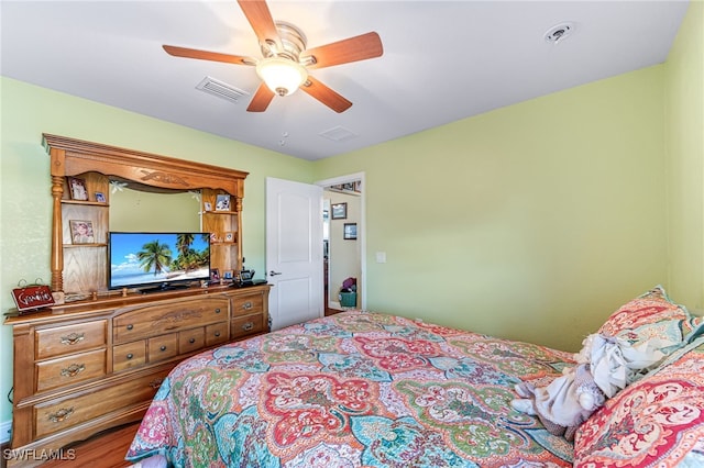 bedroom with wood-type flooring and ceiling fan