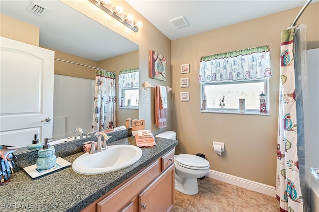 bathroom with tile patterned floors, vanity, and toilet