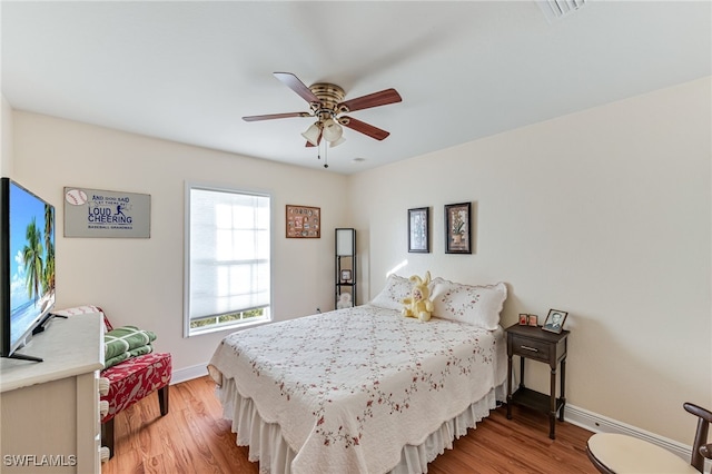 bedroom with ceiling fan and light wood-type flooring