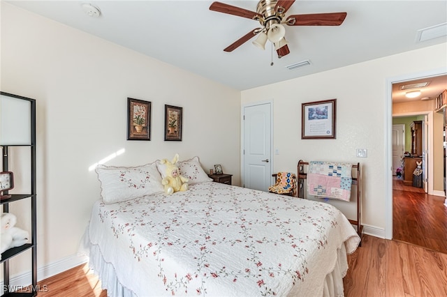 bedroom featuring hardwood / wood-style flooring and ceiling fan