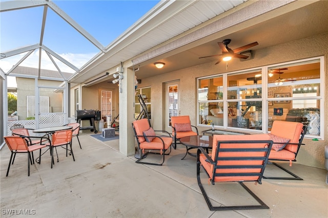 view of patio / terrace featuring ceiling fan and a lanai