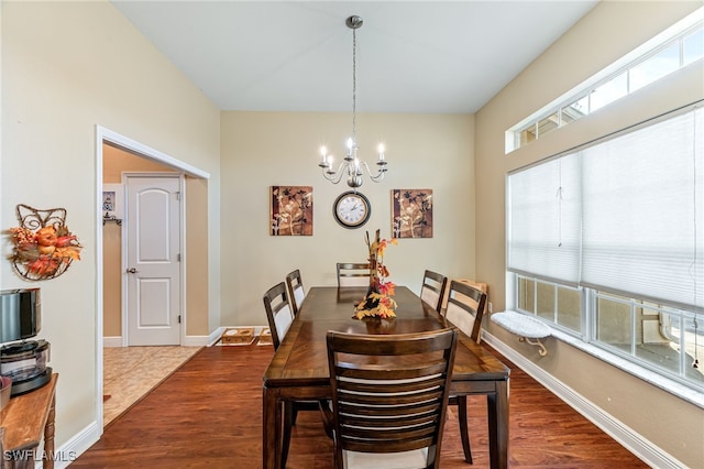 dining room with hardwood / wood-style floors and a chandelier