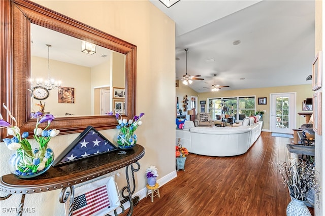 interior space featuring hardwood / wood-style floors and ceiling fan with notable chandelier