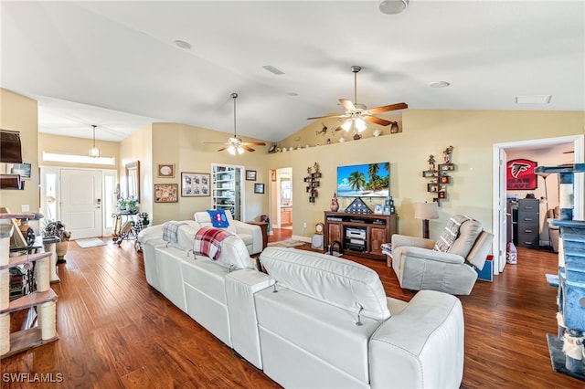 living room featuring plenty of natural light, dark hardwood / wood-style flooring, and vaulted ceiling