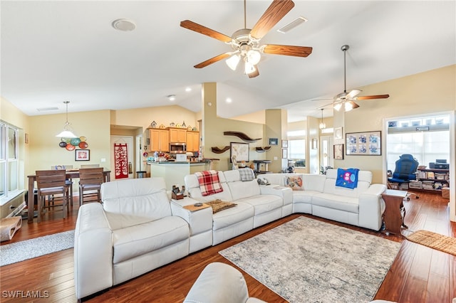 living room featuring lofted ceiling, plenty of natural light, dark wood-type flooring, and ceiling fan