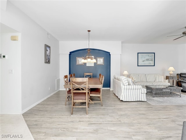 25051 Ballycastle Ct Unit 102, Bonita Springs, FL 34134 - dining room featuring a chandelier, ceiling fan, and light wood finished floors