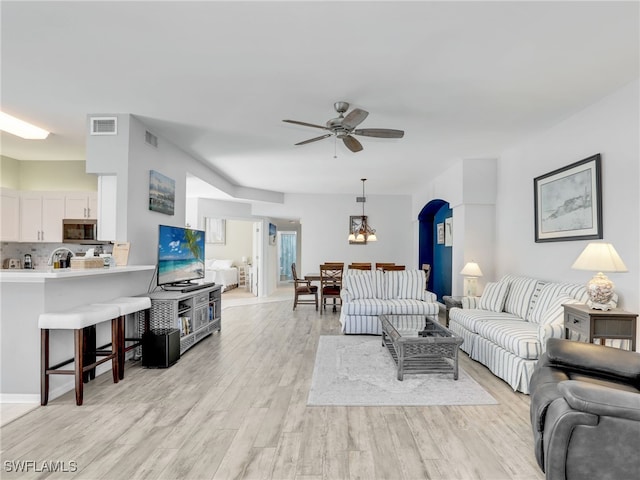 25051 Ballycastle Ct Unit 102, Bonita Springs, FL 34134 - living area with ceiling fan, light wood finished floors, and arched walkways