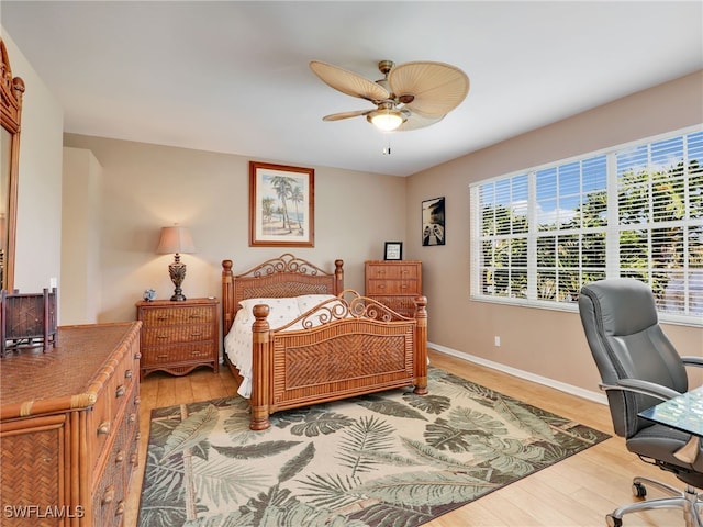 25051 Ballycastle Ct Unit 102, Bonita Springs, FL 34134 - bedroom featuring light wood-style floors, a desk, and a ceiling fan