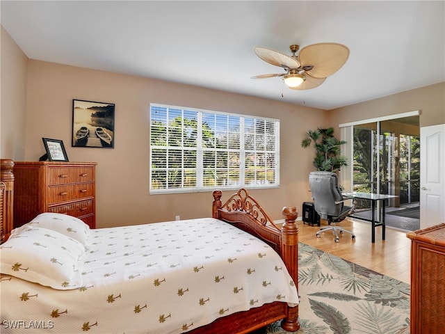 25051 Ballycastle Ct Unit 102, Bonita Springs, FL 34134 - bedroom featuring light wood-style floors, multiple windows, ceiling fan, and a desk