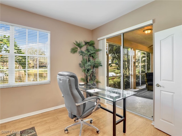 25051 Ballycastle Ct Unit 102, Bonita Springs, FL 34134 - office area featuring light wood-style floors and baseboards