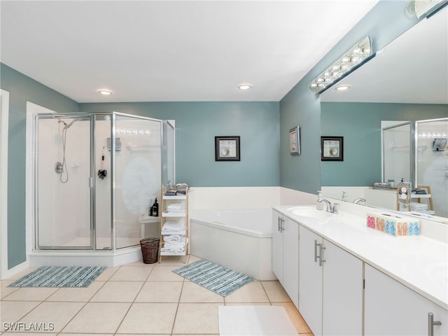 bathroom with tile patterned flooring, shower with separate bathtub, and vanity