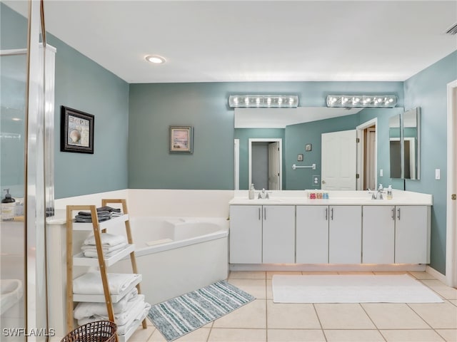 bathroom featuring tile patterned flooring, vanity, and a bathing tub