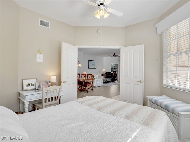 bedroom with ceiling fan and light hardwood / wood-style flooring