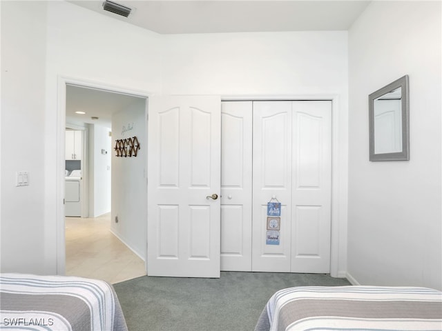25051 Ballycastle Ct Unit 102, Bonita Springs, FL 34134 - bedroom with washer / clothes dryer, carpet, and a closet