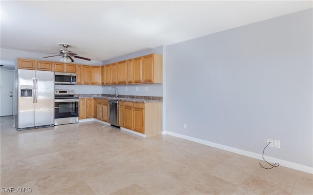 kitchen featuring ceiling fan, sink, and appliances with stainless steel finishes