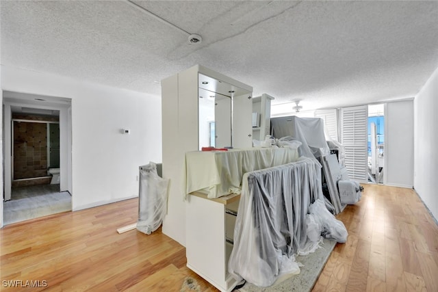 dining space with hardwood / wood-style flooring and a textured ceiling