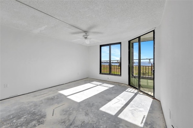 spare room featuring ceiling fan and a textured ceiling