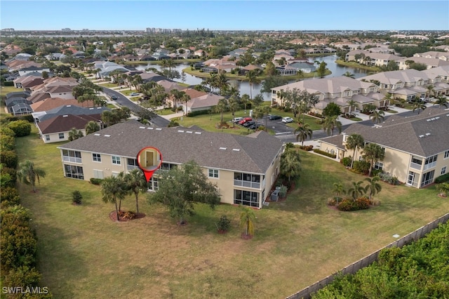 birds eye view of property with a water view and a residential view