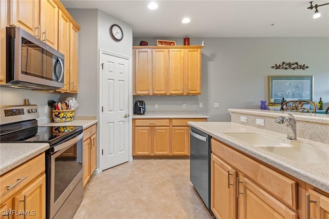 14712 Calusa Palms Dr Unit 103, Fort Myers, FL 33919 - kitchen with stainless steel appliances, light brown cabinetry, light countertops, a sink, and light tile patterned floors