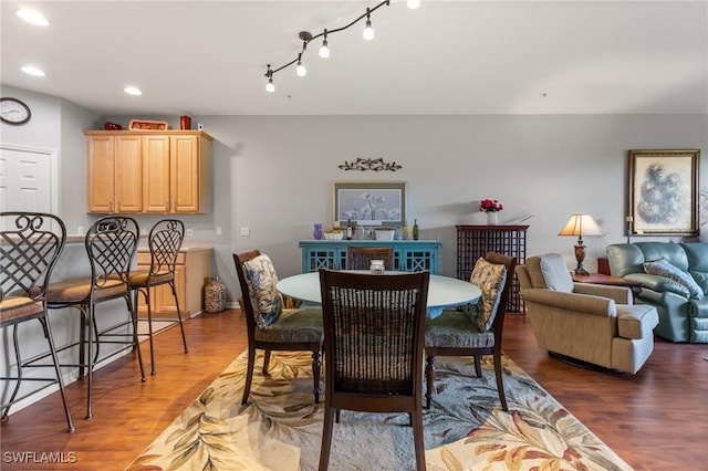 dining area featuring recessed lighting and dark wood-style flooring