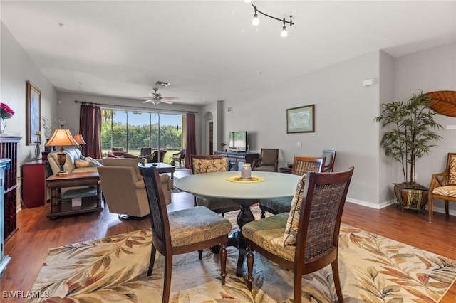 dining area with ceiling fan, visible vents, baseboards, and wood finished floors