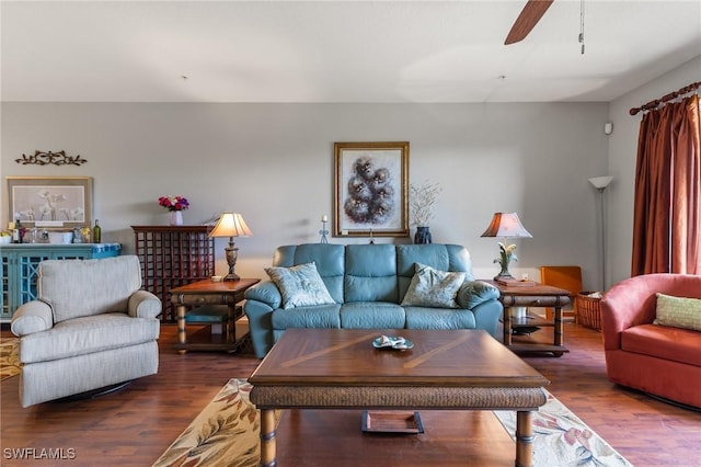 living room featuring dark hardwood / wood-style floors and ceiling fan