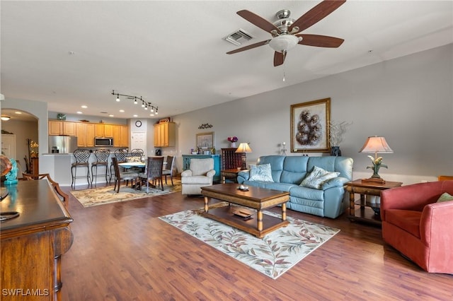 14712 Calusa Palms Dr Unit 103, Fort Myers, FL 33919 - living area with a ceiling fan, wood finished floors, and arched walkways
