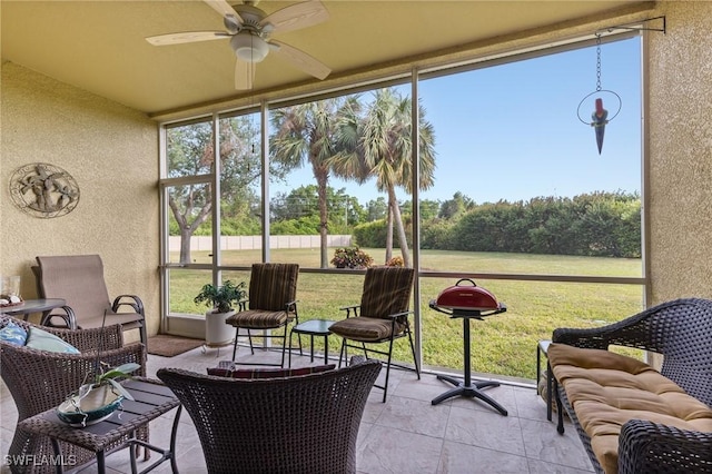 sunroom featuring a ceiling fan