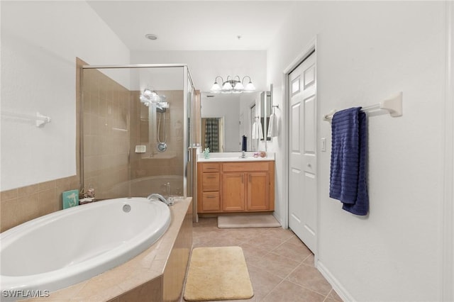 bathroom with tile patterned flooring, shower with separate bathtub, and vanity