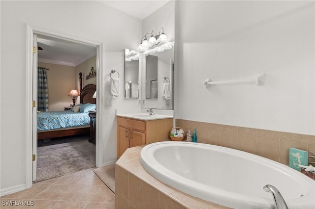 bathroom featuring tiled tub, tile patterned flooring, vanity, and ornamental molding