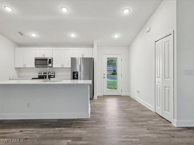 kitchen featuring sink, white cabinets, stainless steel appliances, and dark hardwood / wood-style floors